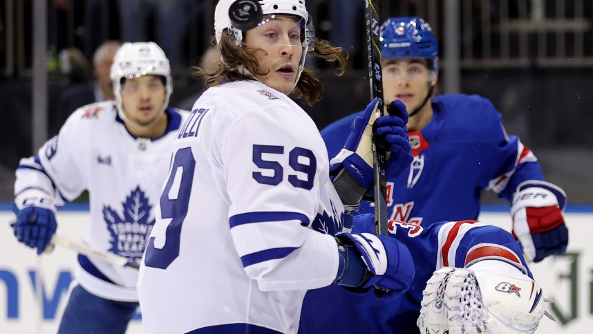 Dec 12, 2023; New York, New York, USA; Toronto Maple Leafs left wing Tyler Bertuzzi (59) watches the puck fly by his head in front of New York Rangers defenseman Braden Schneider (4) and goaltender Igor Shesterkin (31) during the third period at Madison Square Garden. Mandatory Credit: Brad Penner-USA TODAY Sports