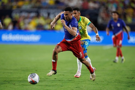 Jun 12, 2024; Orlando, Florida, USA;  United States defender Antonee Robinson (5) and Brazil forward Savio (20) battle for the ball in the second half during the Continental Clasico at Camping World Stadium. Mandatory Credit: Nathan Ray Seebeck-USA TODAY Sports