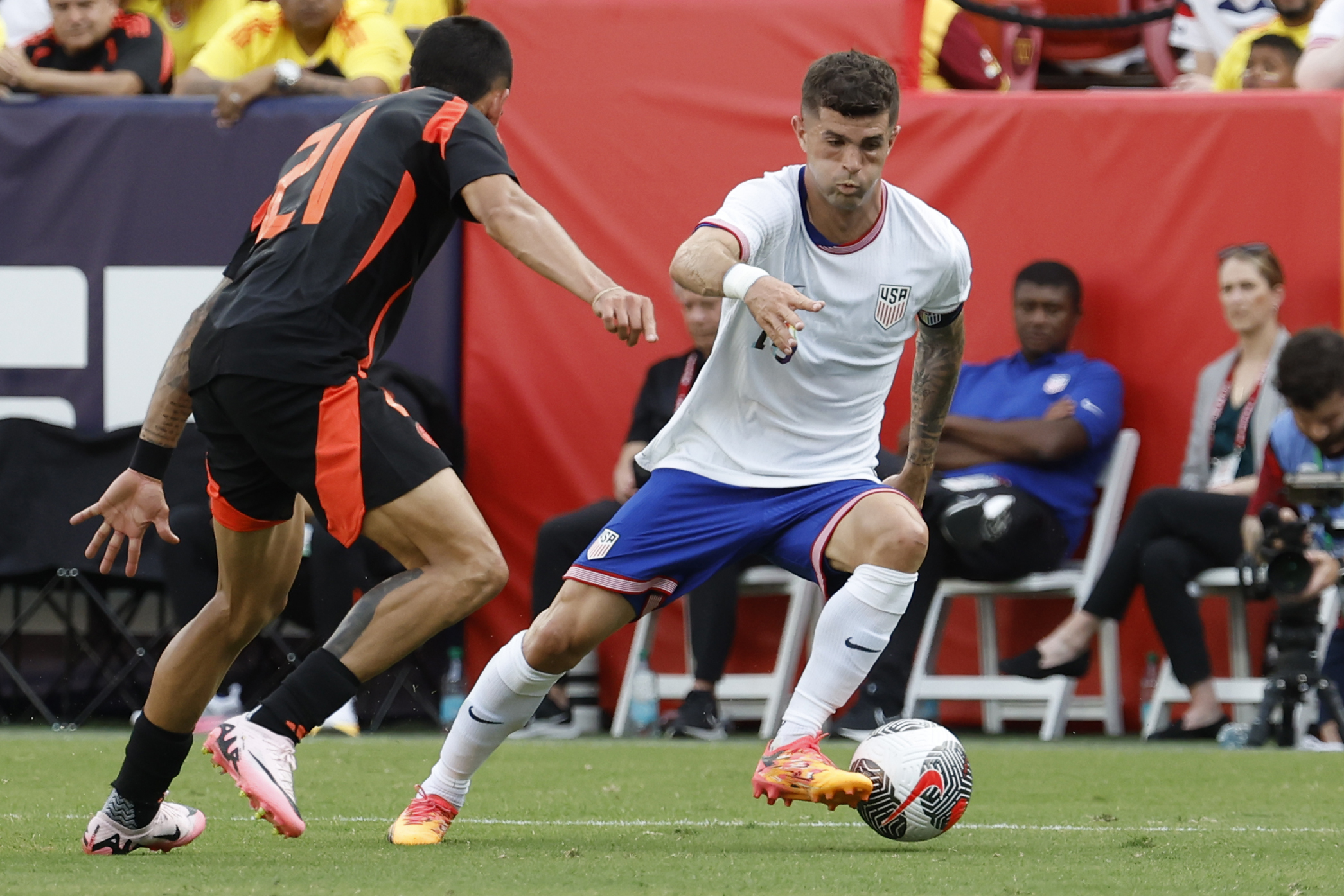 Jun 8, 2024; Landover, Maryland, USA; United States forward Christian Pulisic (10) dribbles the ball as Colombia defender Daniel Munoz (21) defends in the first half at Commanders Field. Mandatory Credit: Geoff Burke-USA TODAY Sports