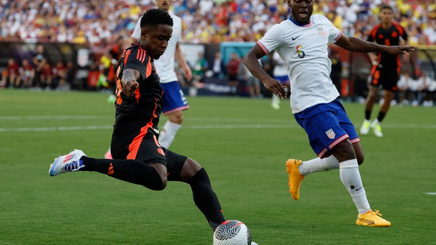 Jun 8, 2024; Landover, Maryland, USA; Colombia forward Rafael Santtos Borre (19) crosses the ball as United States defender Antonee Robinson (5) defends in the second half at Commanders Field. Mandatory Credit: Geoff Burke-USA TODAY Sports