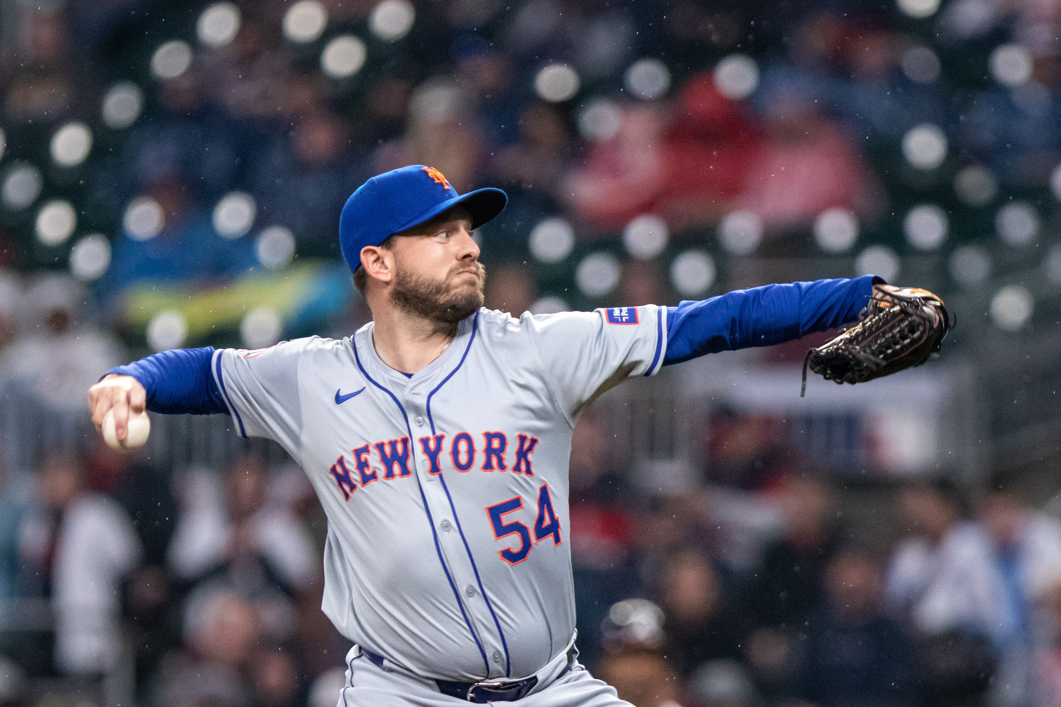 Apr 9, 2024; Cumberland, Georgia, USA; New York Mets pitcher Cole Susler (54) pitches against Atlanta Braves during the eighth inning at Truist Park. Mandatory Credit: Jordan Godfree-USA TODAY Sports