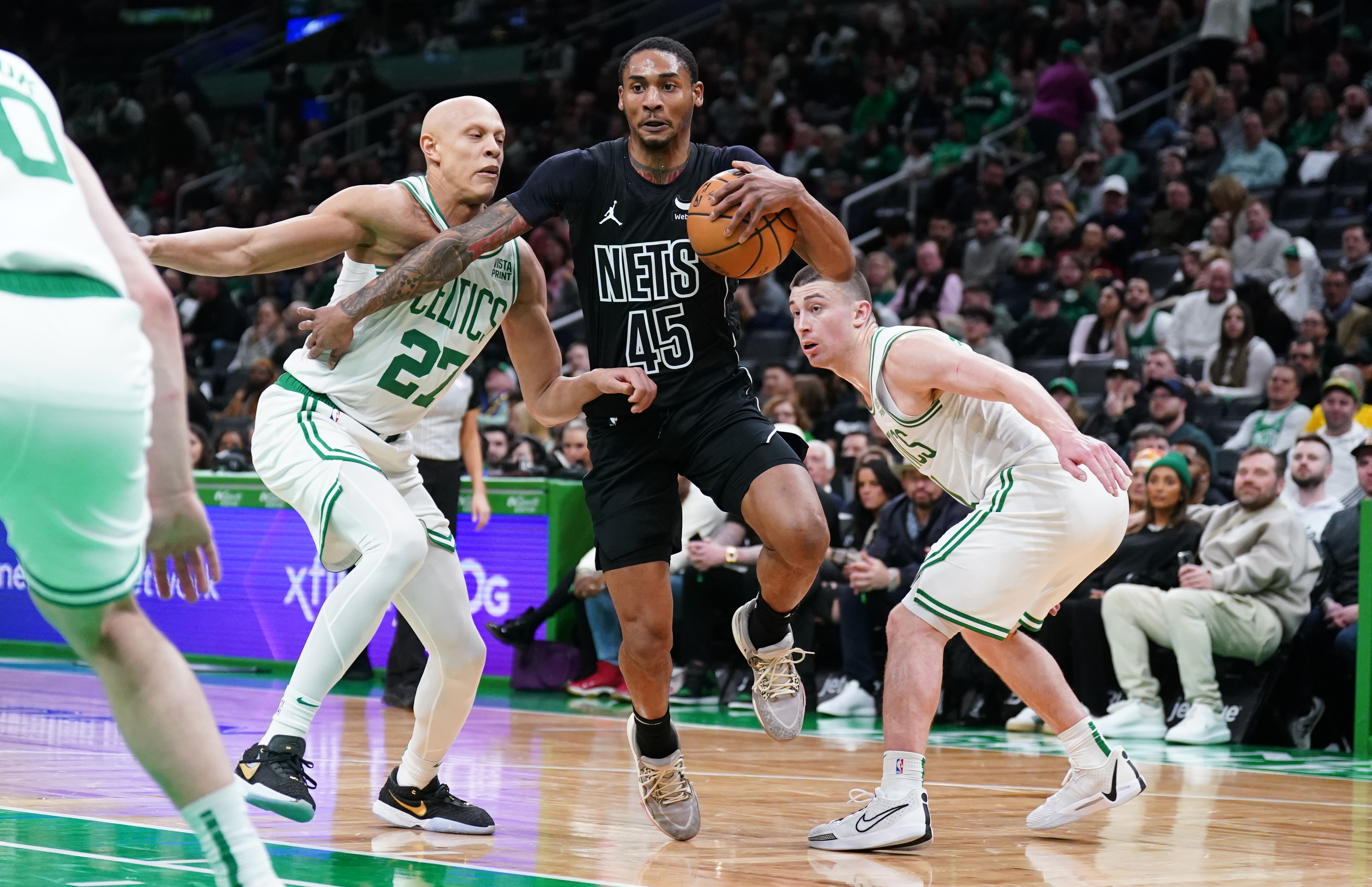 Feb 14, 2024; Boston, Massachusetts, USA; Brooklyn Nets guard Keon Johnson (45) drives the ball against Boston Celtics guard Payton Pritchard (11) and guard Jordan Walsh (27) in the second half at TD Garden. Mandatory Credit: David Butler II-USA TODAY Sports