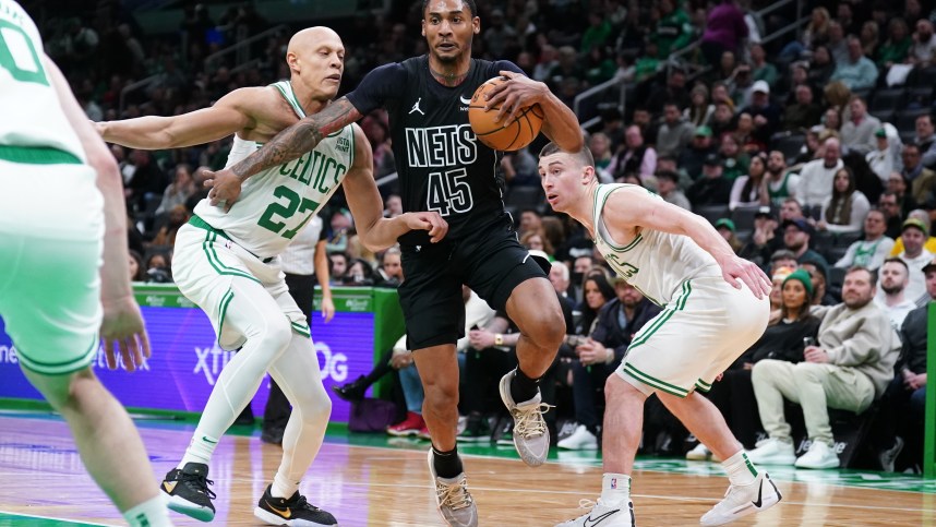 Feb 14, 2024; Boston, Massachusetts, USA; Brooklyn Nets guard Keon Johnson (45) drives the ball against Boston Celtics guard Payton Pritchard (11) and guard Jordan Walsh (27) in the second half at TD Garden. Mandatory Credit: David Butler II-USA TODAY Sports