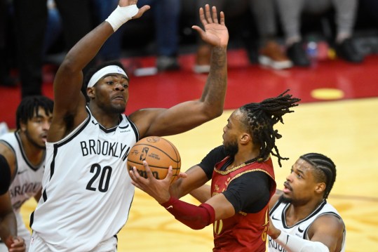 Mar 10, 2024; Cleveland, Ohio, USA; Cleveland Cavaliers guard Darius Garland (10) drives to the basket between Brooklyn Nets center Day'Ron Sharpe (20) and guard Dennis Smith Jr. (4) in the third quarter at Rocket Mortgage FieldHouse. Mandatory Credit: David Richard-USA TODAY Sports