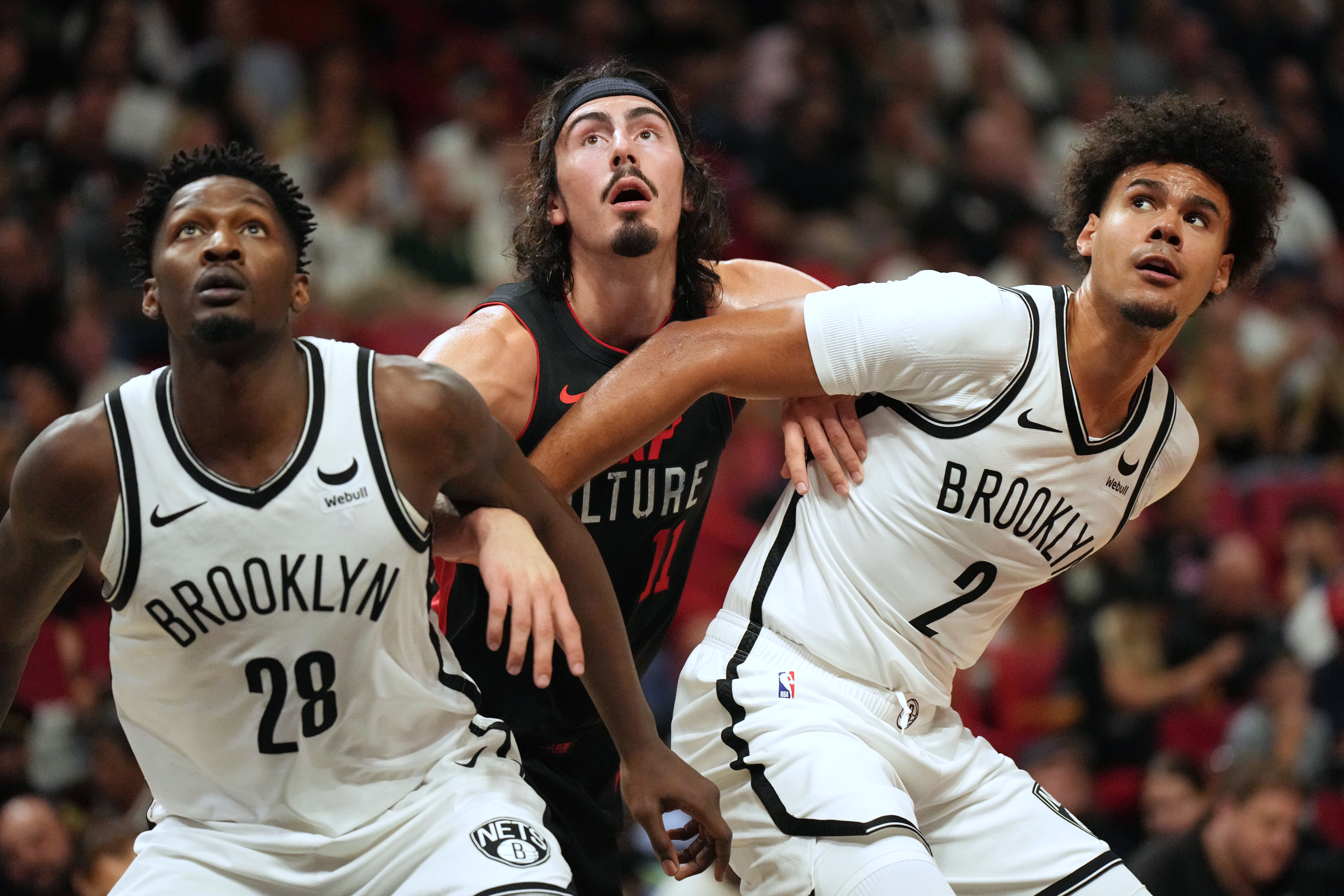 Nov 16, 2023; Miami, Florida, USA;  Miami Heat guard Jaime Jaquez Jr. (11) battles for position with Brooklyn Nets forward Dorian Finney-Smith (28) and forward Cameron Johnson (2) in the first half at Kaseya Center. Mandatory Credit: Jim Rassol-USA TODAY Sports