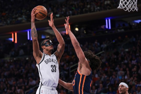 April 12, 2024; New York, New York, USA; Brooklyn Nets center Nic Claxton (33) attempts a basket against New York Knicks center Jericho Sims (45) during the first half at Madison Square Garden. Mandatory Photo Credit: Vincent Carchietta-USA TODAY Sports