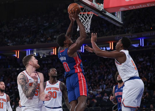 Nov 30, 2023; New York, New York, USA; Detroit Pistons center Jalen Duren (0) shoots the ball as New York Knicks guard RJ Barrett (9) and forward Julius Randle (30) and center Isaiah Hartenstein (55) defend during the second half at Madison Square Garden. Mandatory Credit: Vincent Carchietta-USA TODAY Sports