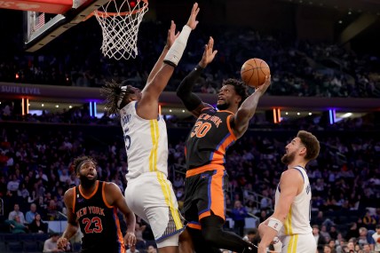 Dec 20, 2022; New York, New York, USA; New York Knicks forward Julius Randle (30) drives to the basket against Golden State Warriors center Kevon Looney (5) during the third quarter at Madison Square Garden. Mandatory Credit: Brad Penner-USA TODAY Sports