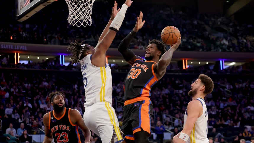 Dec 20, 2022; New York, New York, USA; New York Knicks forward Julius Randle (30) drives to the basket against Golden State Warriors center Kevon Looney (5) during the third quarter at Madison Square Garden. Mandatory Credit: Brad Penner-USA TODAY Sports