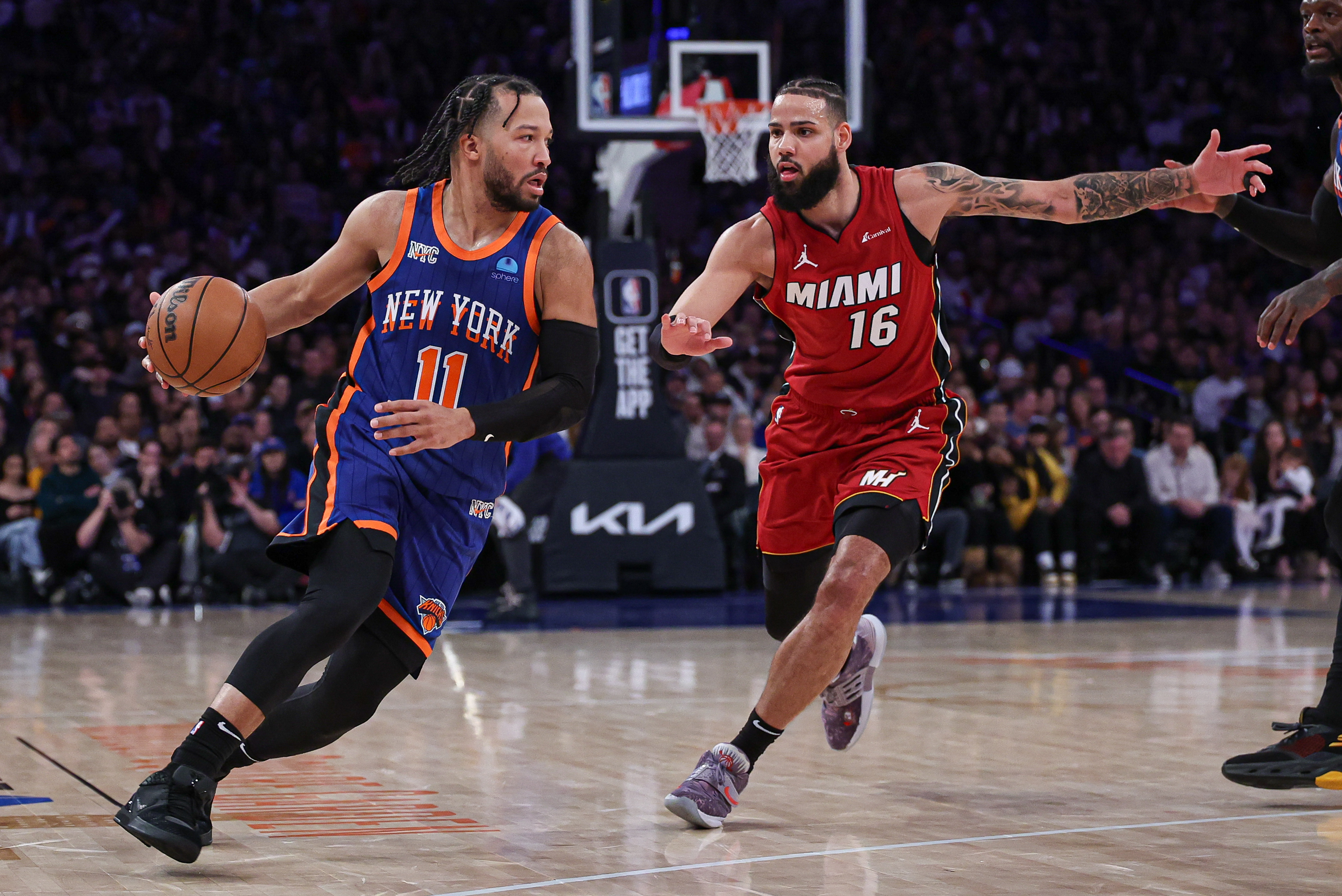 Jan 27, 2024; New York, New York, USA; New York Knicks guard Jalen Brunson (11) dribbles against Miami Heat forward Caleb Martin (16) during the second half at Madison Square Garden. Mandatory Credit: Vincent Carchietta-USA TODAY Sports