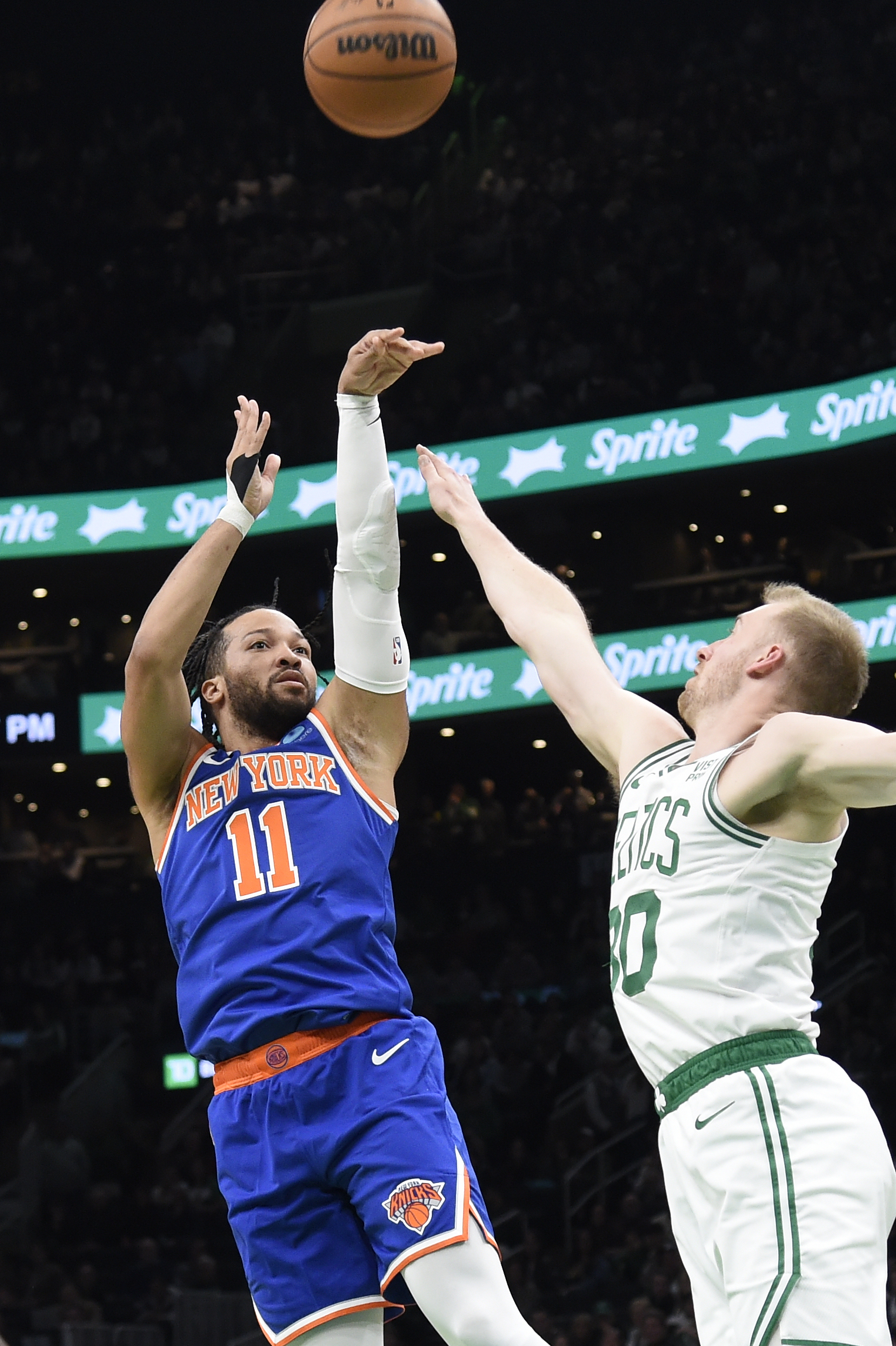 Apr 11, 2024; Boston, Massachusetts, USA;  New York Knicks guard Jalen Brunson (11) shoots the ball past Boston Celtics forward Sam Hauser (30) during the first half at TD Garden. Mandatory Credit: Bob DeChiara-USA TODAY Sports