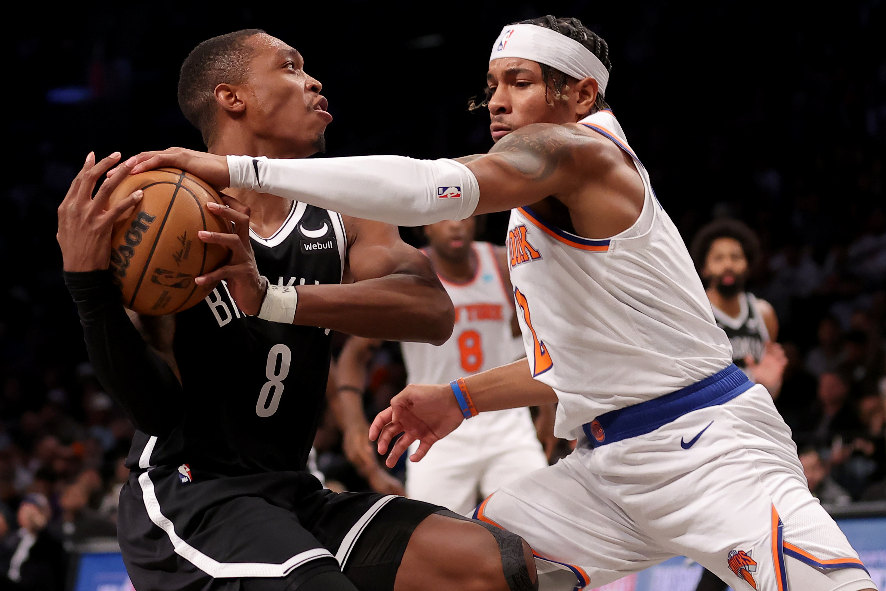 Jan 23, 2024; Brooklyn, New York, USA; New York Knicks guard Miles McBride (2) knocks the ball away from Brooklyn Nets guard Lonnie Walker IV (8) during the fourth quarter at Barclays Center. Mandatory Credit: Brad Penner-USA TODAY Sports