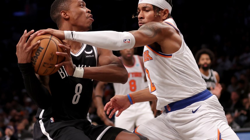 Jan 23, 2024; Brooklyn, New York, USA; New York Knicks guard Miles McBride (2) knocks the ball away from Brooklyn Nets guard Lonnie Walker IV (8) during the fourth quarter at Barclays Center. Mandatory Credit: Brad Penner-USA TODAY Sports