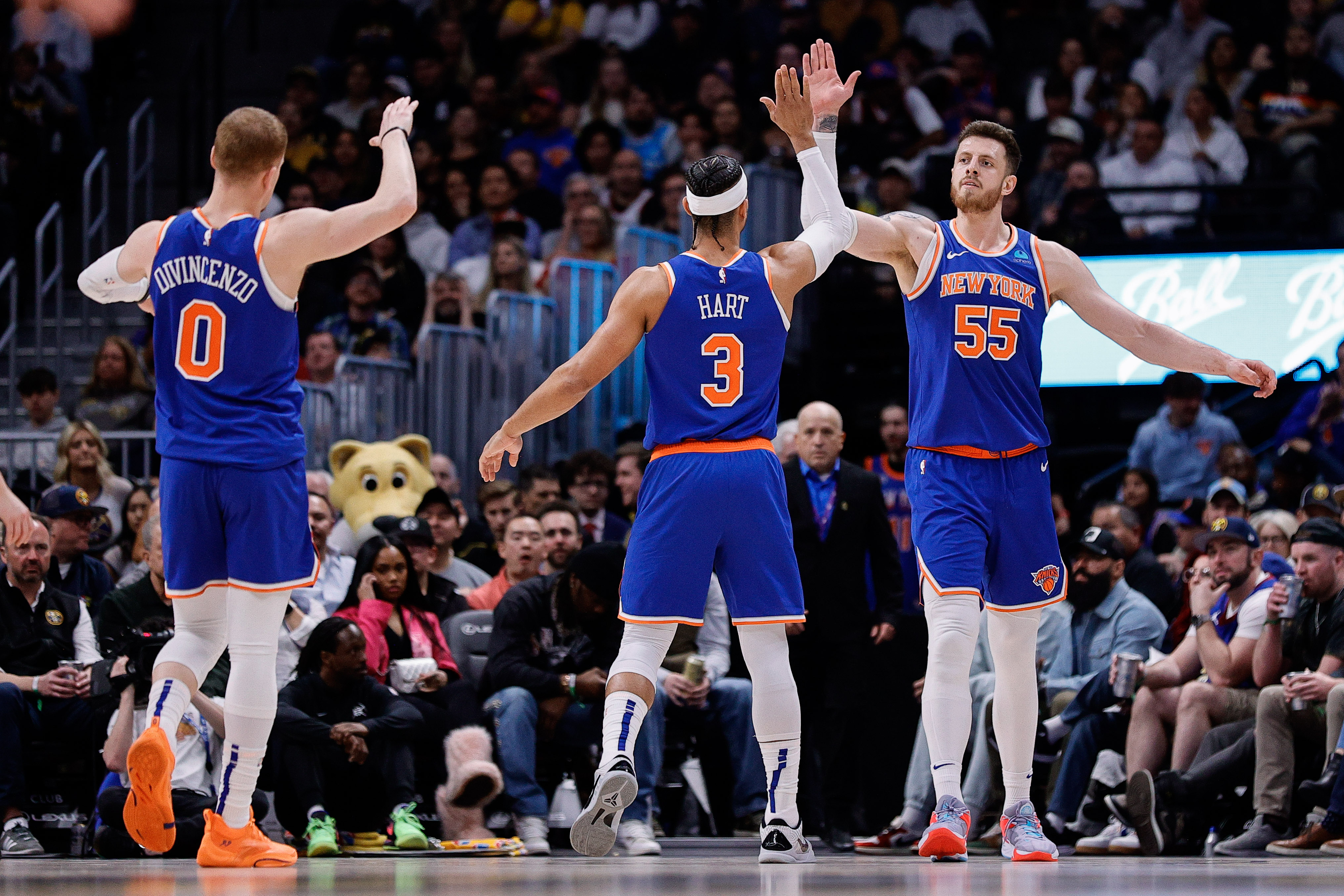 Mar 21, 2024; Denver, Colorado, USA; New York Knicks center Isaiah Hartenstein (55) reacts with guard Josh Hart (3) and guard Donte DiVincenzo (0) in the second quarter against the Denver Nuggets at Ball Arena. Mandatory Credit: Isaiah J. Downing-USA TODAY Sports