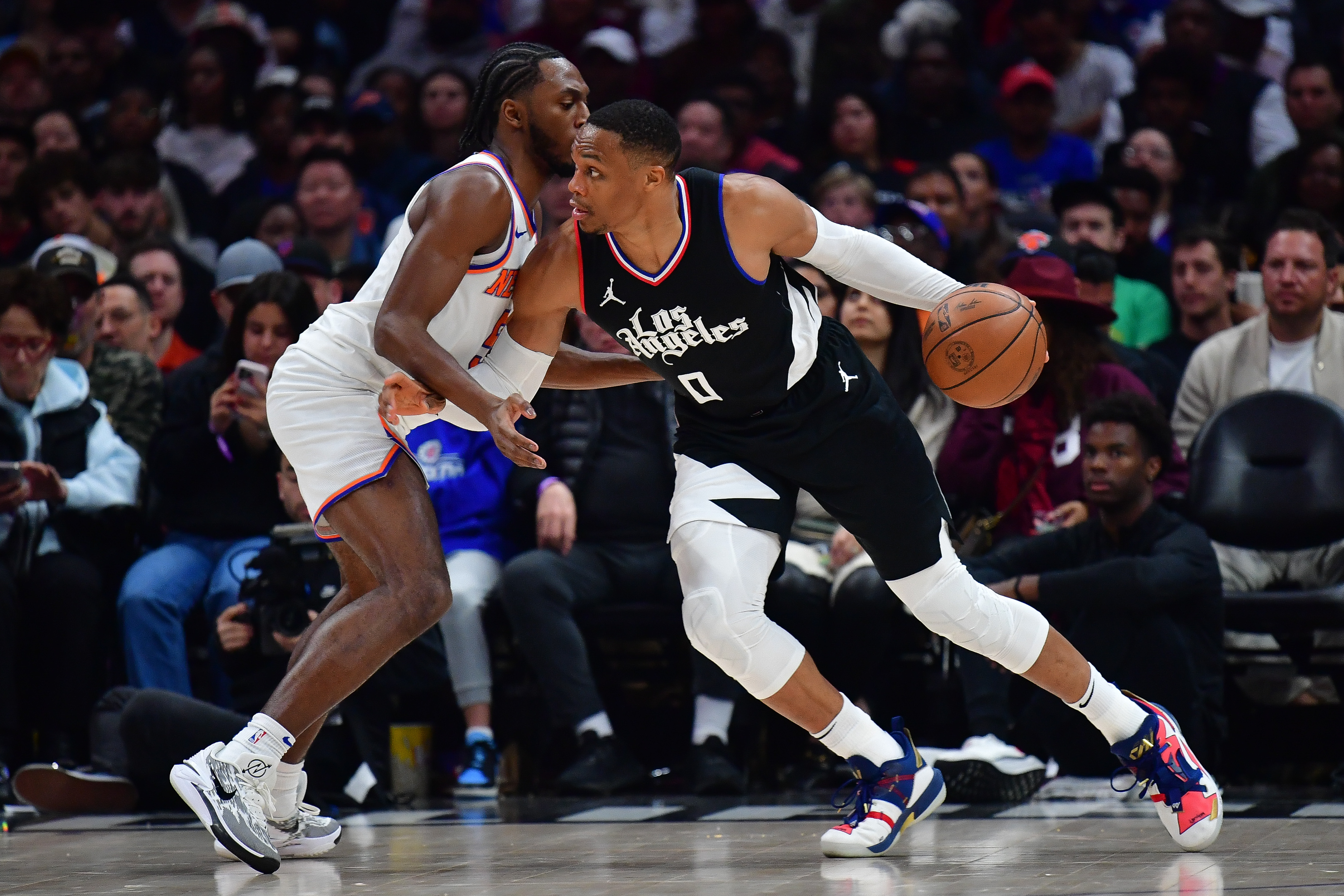 Dec 16, 2023; Los Angeles, California, USA; Los Angeles Clippers guard Russell Westbrook (0) moves the ball against New York Knicks guard Immanuel Quickley (5) during the second half at Crypto.com Arena. Mandatory Credit: Gary A. Vasquez-USA TODAY Sports