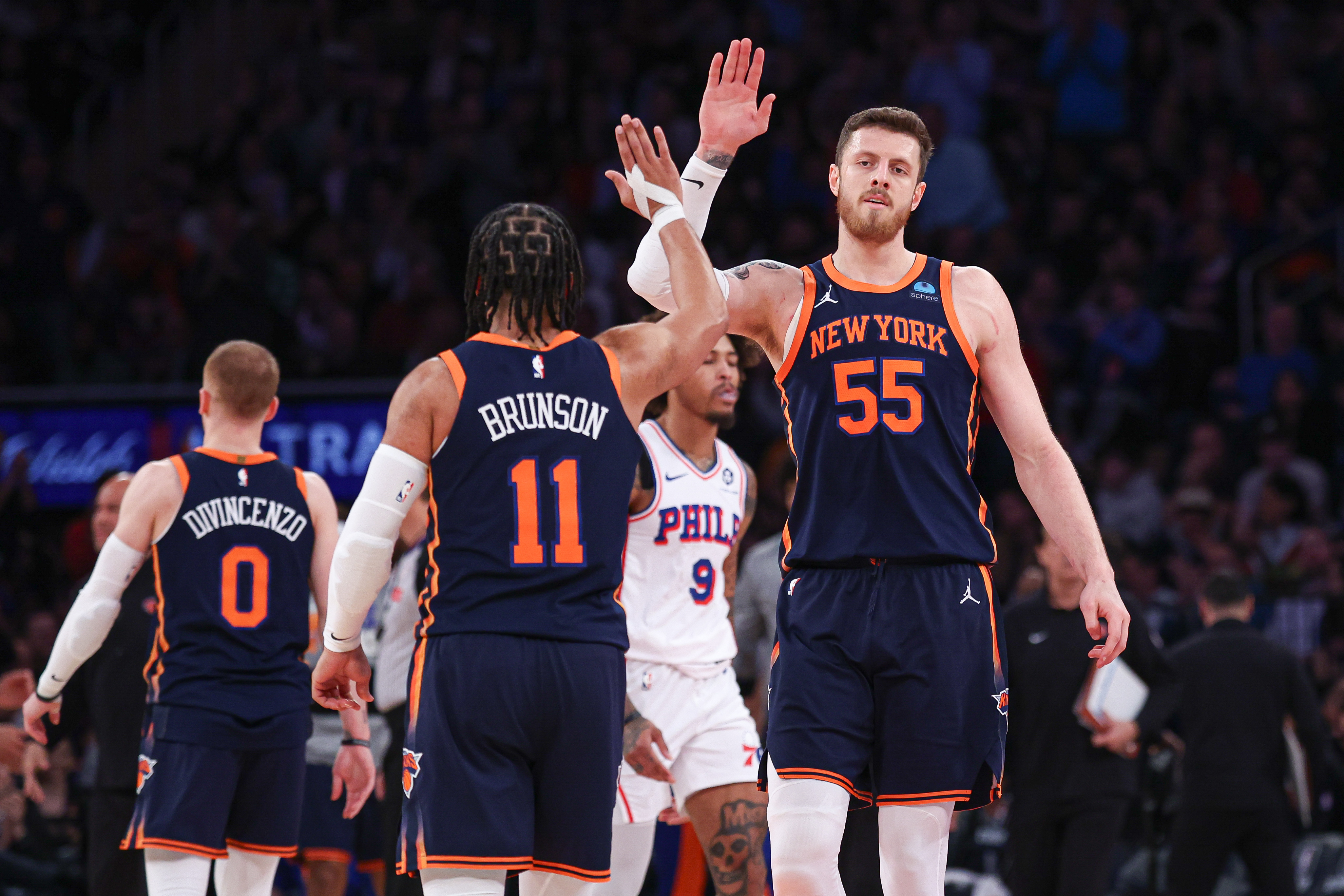 Mar 12, 2024; New York, New York, USA; New York Knicks center Isaiah Hartenstein (55) slaps hands with guard Jalen Brunson (11) during the second quarter against the Philadelphia 76ers at Madison Square Garden. Mandatory Credit: Vincent Carchietta-USA TODAY Sports