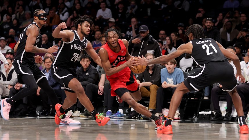 Apr 10, 2024; Brooklyn, New York, USA; Toronto Raptors guard Immanuel Quickley (5) drives to the basket against Brooklyn Nets center Nic Claxton (33) and guard Cam Thomas (24) and forward Noah Clowney (21) during the fourth quarter at Barclays Center. Mandatory Credit: Brad Penner-USA TODAY Sports