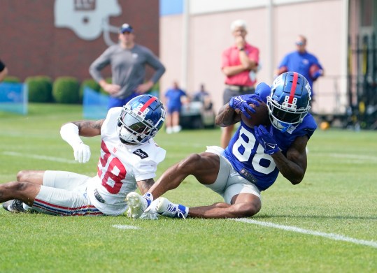 Jul 27, 2023; East Rutherford, NJ, USA;  New York Giants wide receiver Jaydon Mickens (88) makes a catch over cornerback Cor'Dale Flott (28) on day two of training camp at the Quest Diagnostics Training Facility. Mandatory Credit: Danielle Parhizkaran-USA TODAY Sports