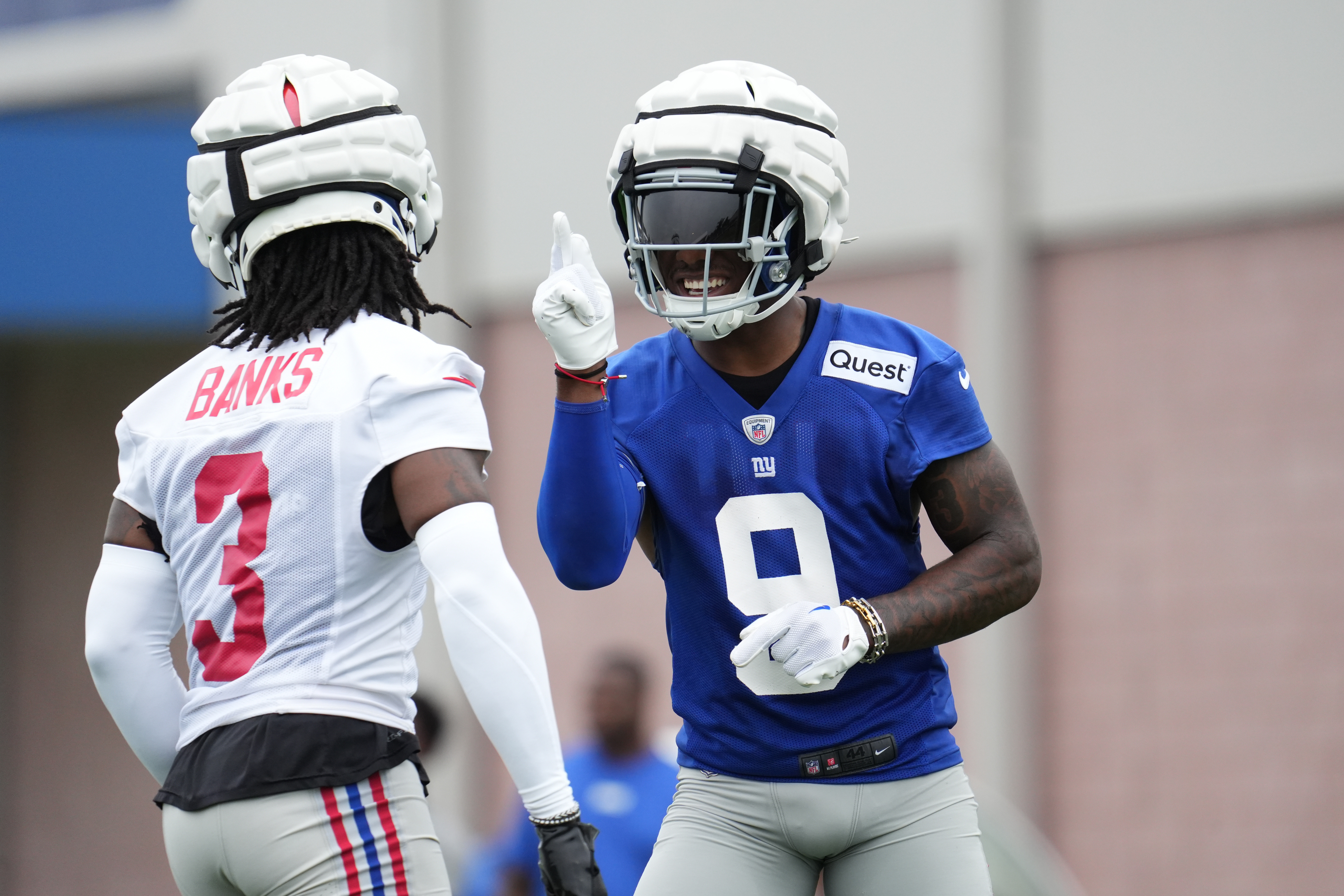 Jul 25, 2024; East Rutherford, NY, USA; New York Giants wide receiver Malik Nabers (9) and cornerback Deonte Banks (3) react after a drill during training camp at Quest Diagnostics Training Center. Mandatory Credit: Lucas Boland-USA TODAY Sports