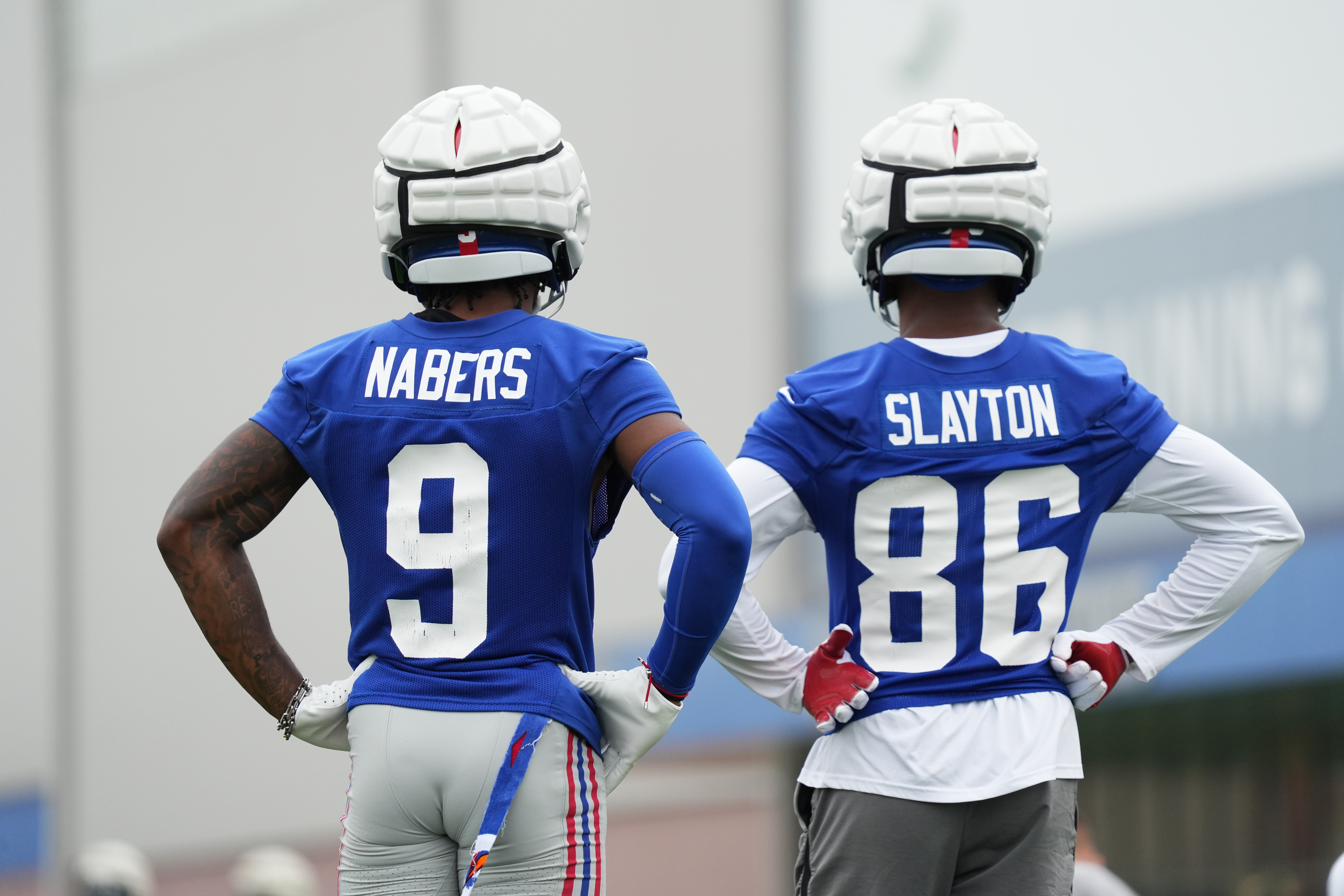 Jul 25, 2024; East Rutherford, NY, USA; New York Giants wide receiver Malik Nabers (9) and wide receiver Darius Slayton (86) look on during training camp at Quest Diagnostics Training Center. Mandatory Credit: Lucas Boland-USA TODAY Sports