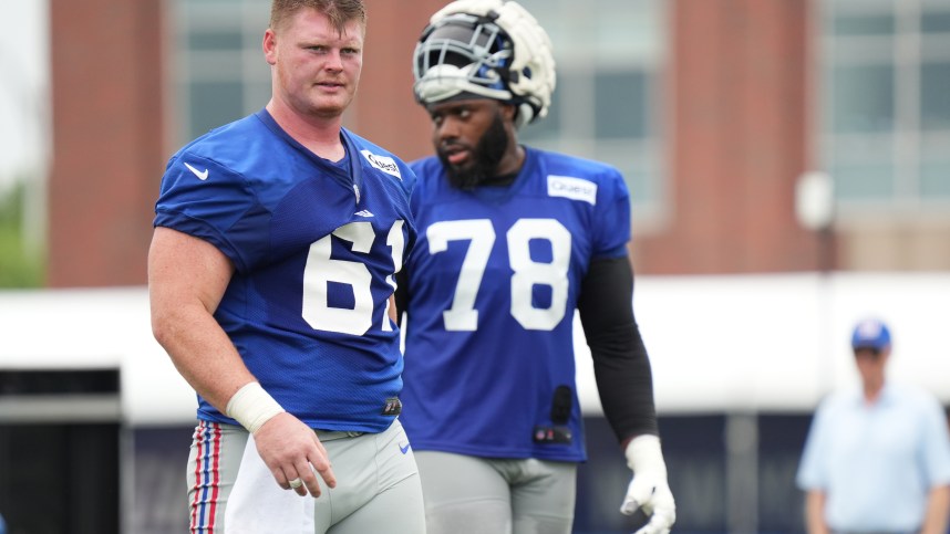 Jul 25, 2024; East Rutherford, NY, USA; New York Giants center John Michael Schmitz Jr. (61) takes a water break alongside offensive tackle Andrew Thomas (78) during training camp at Quest Diagnostics Training Center. Mandatory Credit: Lucas Boland-USA TODAY Sports