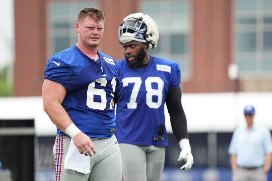 Jul 25, 2024; East Rutherford, NY, USA; New York Giants center John Michael Schmitz Jr. (61) takes a water break alongside offensive tackle Andrew Thomas (78) during training camp at Quest Diagnostics Training Center. Mandatory Credit: Lucas Boland-USA TODAY Sports