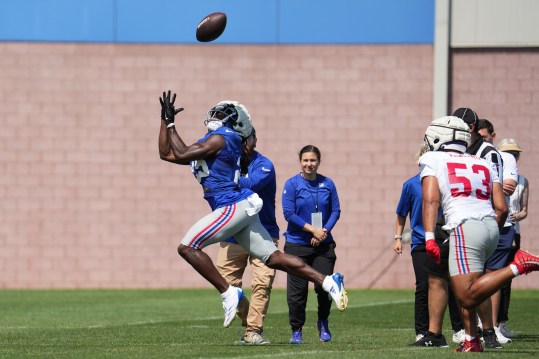 Jul 26, 2024; East Rutherford, NJ, USA; New York Giants running back Dante Miller (25) catches a pass as New York Giants linebacker Darius Muasau (53) trails during training camp at Quest Diagnostics Training Center. Mandatory Credit: Lucas Boland-USA TODAY Sports