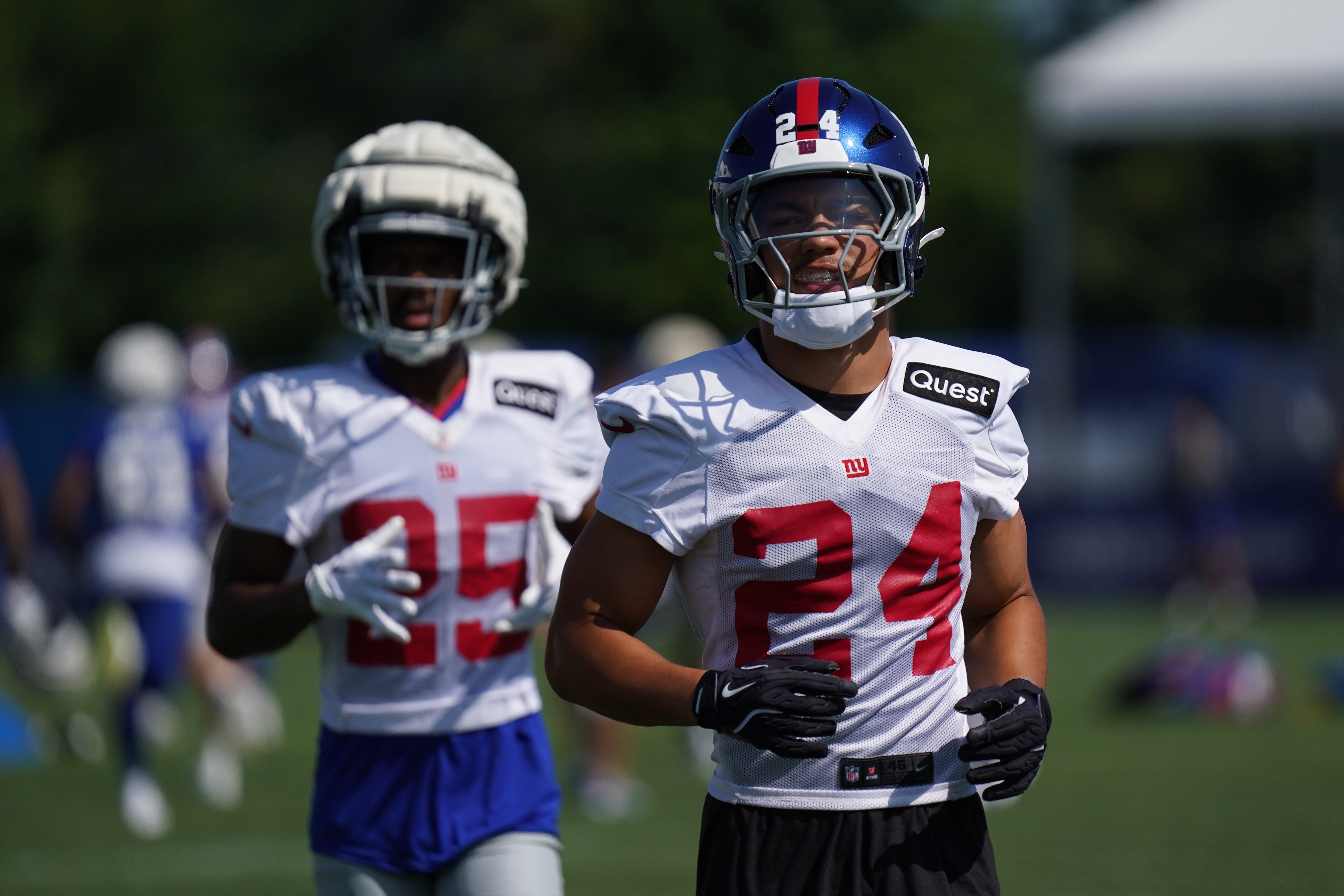 Jul 26, 2024; East Rutherford, NJ, USA; New York Giants safety Dane Belton (24) and New York Giants defensive back Alex Johnson (25) take the field during training camp at Quest Diagnostics Training Center. Mandatory Credit: Lucas Boland-USA TODAY Sports