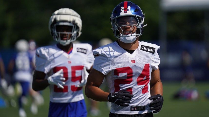 Jul 26, 2024; East Rutherford, NJ, USA; New York Giants safety Dane Belton (24) and New York Giants defensive back Alex Johnson (25) take the field during training camp at Quest Diagnostics Training Center. Mandatory Credit: Lucas Boland-USA TODAY Sports