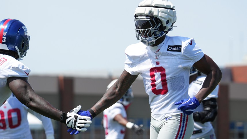 Jul 26, 2024; East Rutherford, NJ, USA; New York Giants linebacker Brian Burns (0) high fives New York Giants defensive tackle Rakeem Nunez-Roches (93) during training camp at Quest Diagnostics Training Center. Mandatory Credit: Lucas Boland-USA TODAY Sports