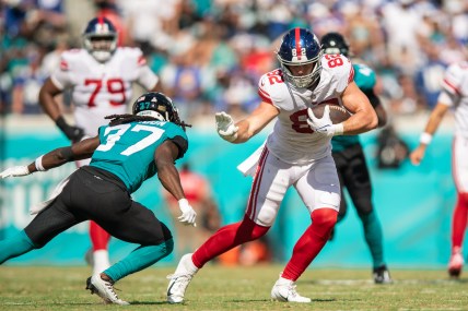 Oct 23, 2022; Jacksonville, Florida, USA;  New York Giants tight end Daniel Bellinger (82) catches the ball against Jacksonville Jaguars cornerback Tre Herndon (37) in the second quarter at TIAA Bank Field. Mandatory Credit: Jeremy Reper-USA TODAY Sports