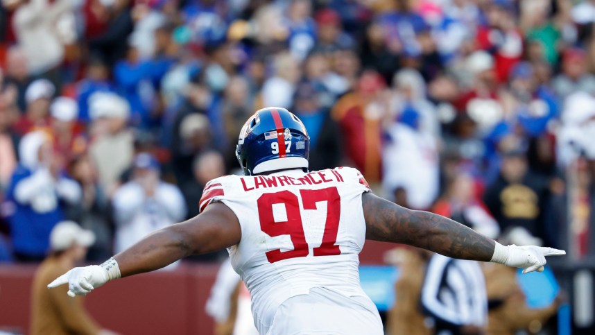 Nov 19, 2023; Landover, Maryland, USA; New York Giants defensive tackle Dexter Lawrence II (97) celebrates after an interception against the Washington Commanders during the fourth quarter at FedExField. Mandatory Credit: Geoff Burke-USA TODAY Sports