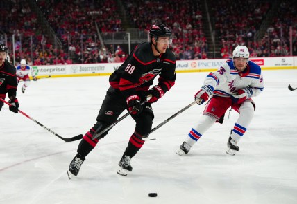 May 9, 2024; Raleigh, North Carolina, USA; Carolina Hurricanes center Martin Necas (88) skates with the puck past New York Rangers defenseman Ryan Lindgren (55) during the third period in game three of the second round of the 2024 Stanley Cup Playoffs at PNC Arena. Mandatory Credit: James Guillory-USA TODAY Sports
