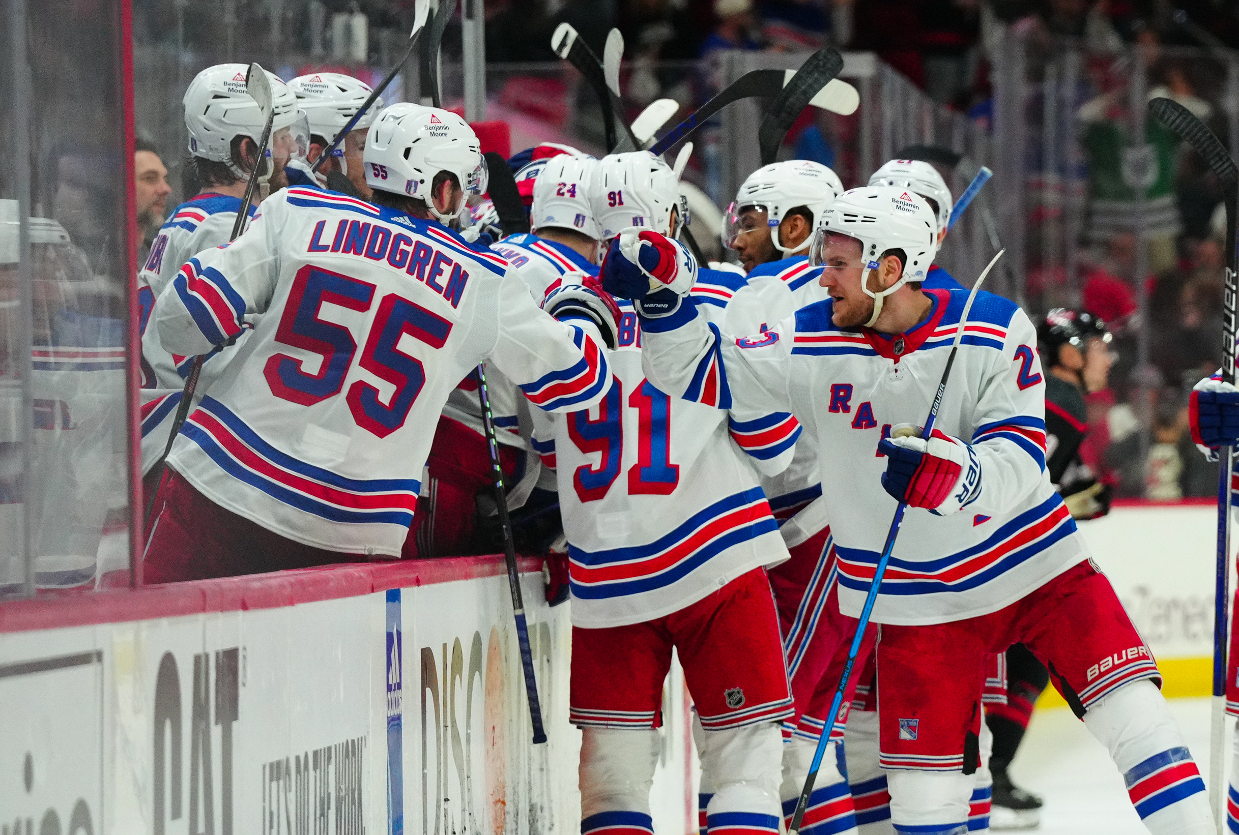 May 16, 2024; Raleigh, North Carolina, USA; New York Rangers defenseman Adam Fox (23) and defenseman Ryan Lindgren (55) celebrate center Barclay Goodrow (21) (not shown) goal against the Carolina Hurricanes during the third period in game six of the second round of the 2024 Stanley Cup Playoffs at PNC Arena. Mandatory Credit: James Guillory-USA TODAY Sports