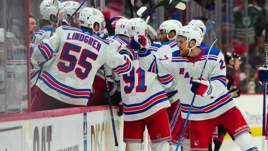 May 16, 2024; Raleigh, North Carolina, USA; New York Rangers defenseman Adam Fox (23) and defenseman Ryan Lindgren (55) celebrate center Barclay Goodrow (21) (not shown) goal against the Carolina Hurricanes during the third period in game six of the second round of the 2024 Stanley Cup Playoffs at PNC Arena. Mandatory Credit: James Guillory-USA TODAY Sports