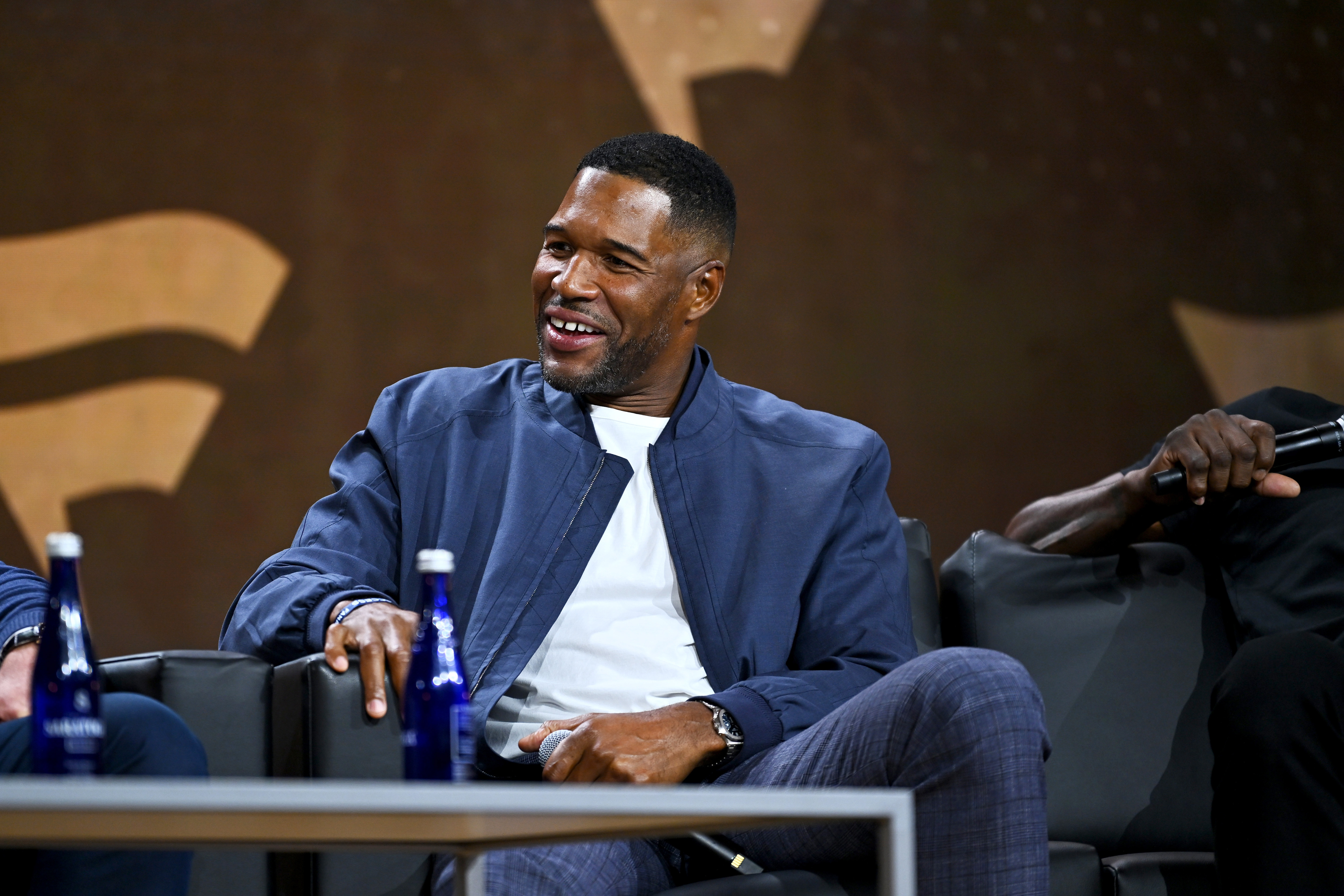 NEW YORK, NEW YORK - AUGUST 16: Giants legend Michael Strahan speaks onstage at the Fanatics Fest NYC 2024 at Jacob Javits Center on August 16, 2024 in New York City. (Photo by Roy Rochlin/Getty Images for Fanatics)