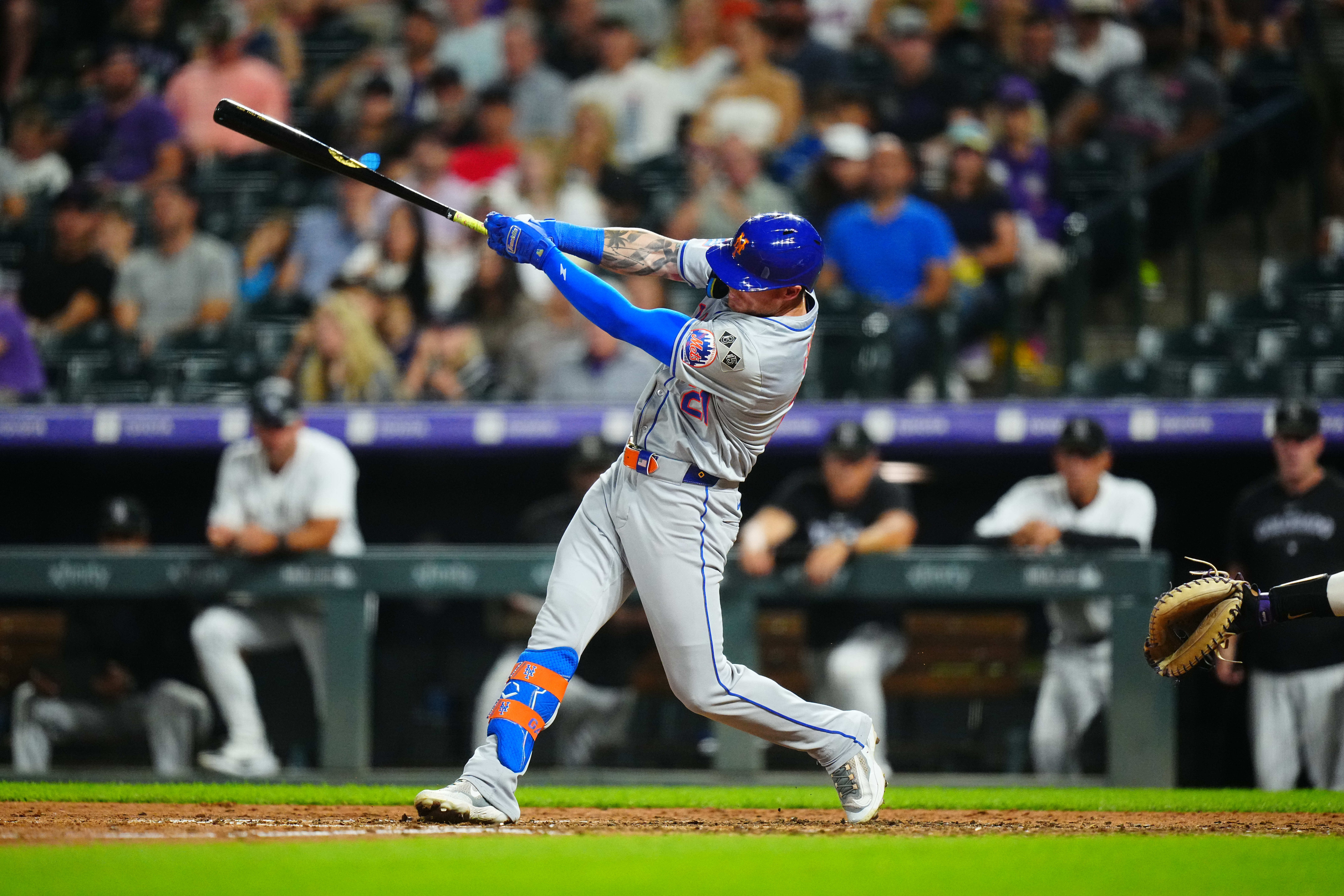 Aug 7, 2024; Denver, Colorado, USA; New York Mets outfielder Ben Gamel (21) singles in the seventh inning against the Colorado Rockies at Coors Field. Mandatory Credit: Ron Chenoy-USA TODAY Sports