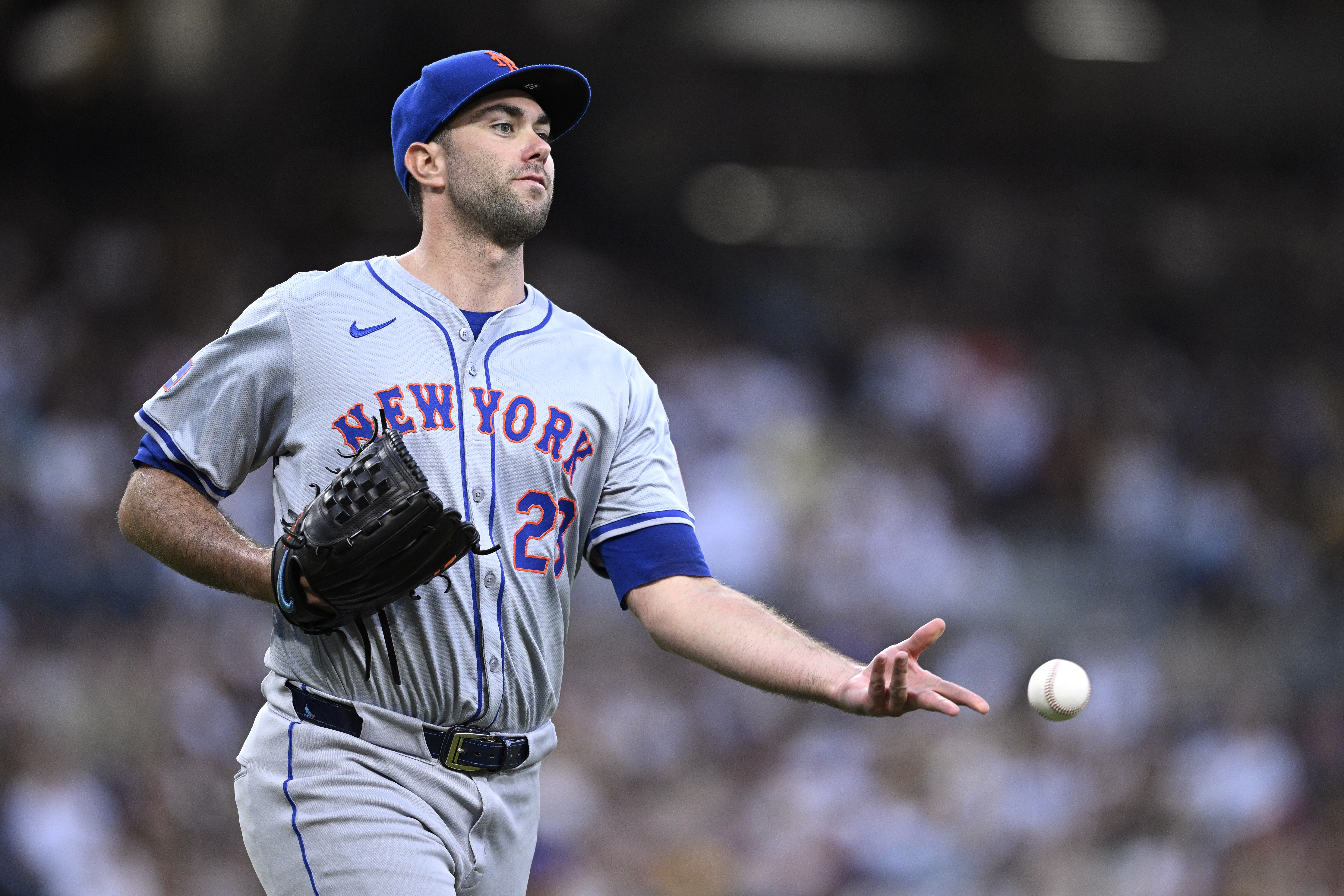 Aug 24, 2024; San Diego, California, USA; New York Mets starting pitcher David Peterson (23) tosses the ball to first base during the fifth inning against the San Diego Padres at Petco Park. Mandatory Credit: Orlando Ramirez-USA TODAY Sports