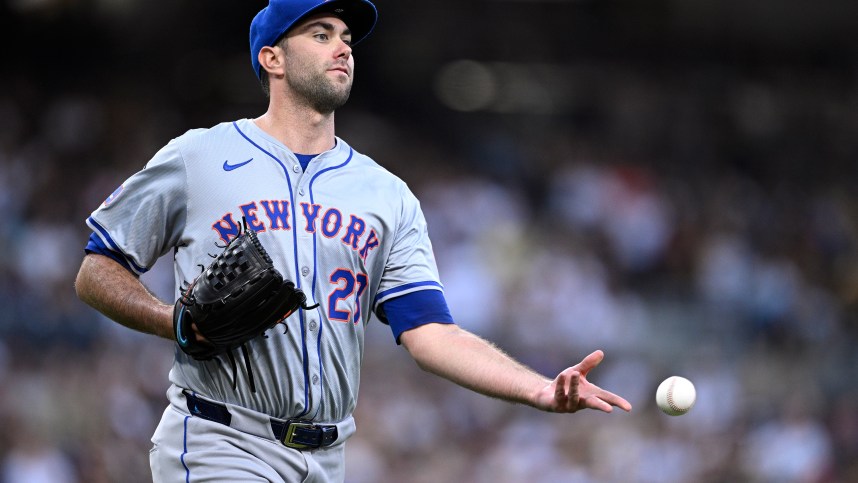 Aug 24, 2024; San Diego, California, USA; New York Mets starting pitcher David Peterson (23) tosses the ball to first base during the fifth inning against the San Diego Padres at Petco Park. Mandatory Credit: Orlando Ramirez-USA TODAY Sports