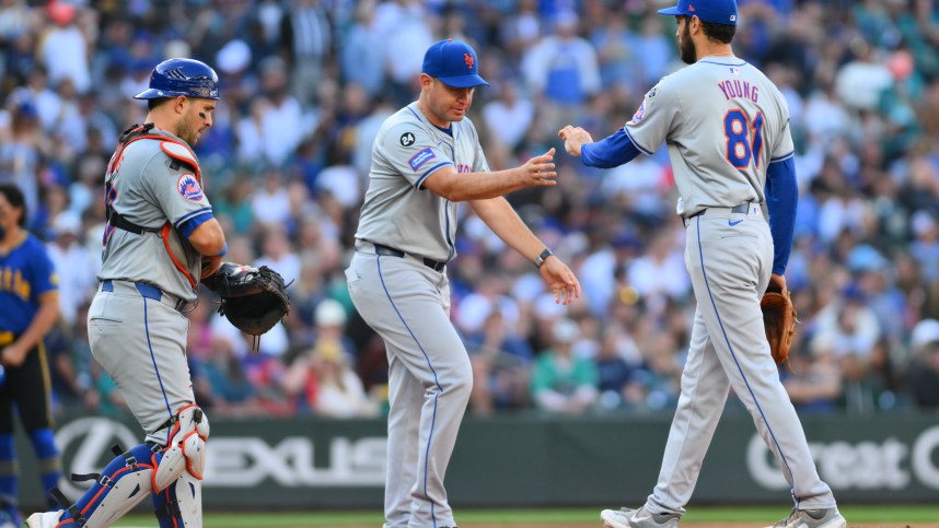 Aug 11, 2024; Seattle, Washington, USA; New York Mets manager Carlos Mendoza (64) pulls relief pitcher Danny Young (81) from the game during the seventh inning against the Seattle Mariners at T-Mobile Park. Mandatory Credit: Steven Bisig-USA TODAY Sports