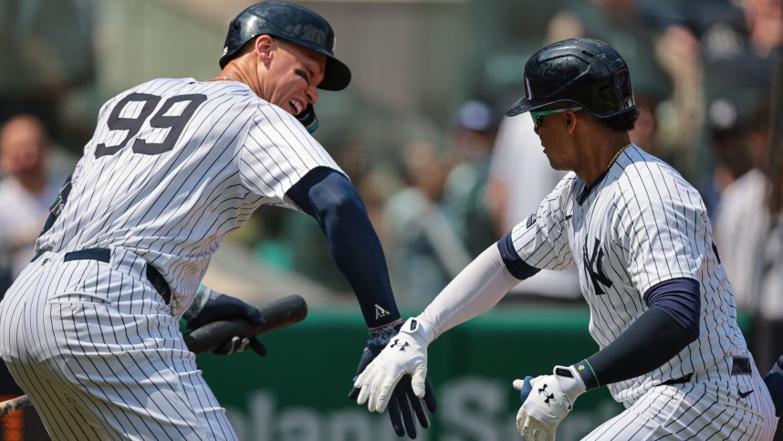 Aug 11, 2024; Bronx, New York, USA; New York Yankees right fielder Juan Soto (22) celebrates with New York Yankees center fielder Aaron Judge (99) after hitting a solo home run during the third inning against the Texas Rangers at Yankee Stadium. Mandatory Credit: Vincent Carchietta-USA TODAY Sports, MLB