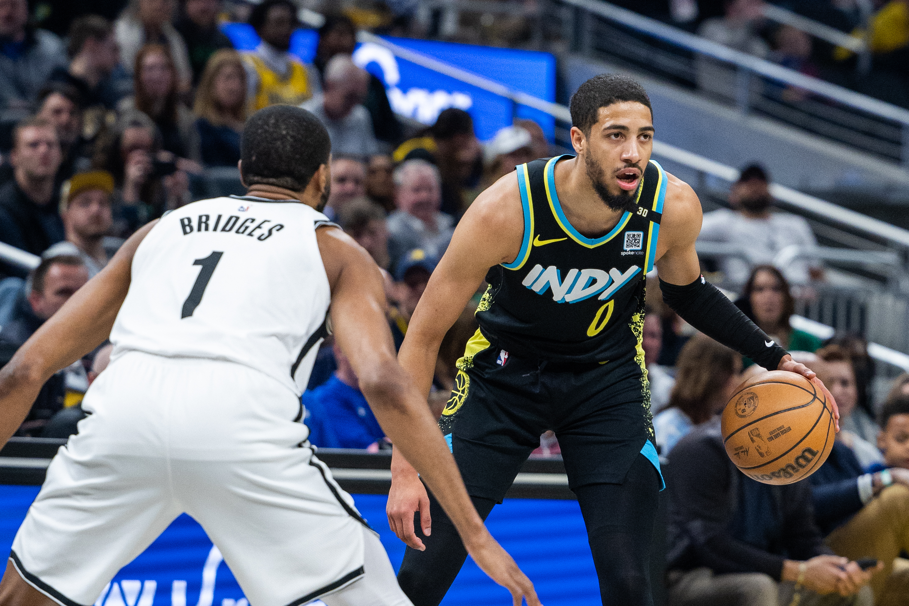 Mar 16, 2024; Indianapolis, Indiana, USA;  Indiana Pacers guard Tyrese Haliburton (0) dribbles the ball while Brooklyn Nets forward Mikal Bridges (1) (New York Knicks)defends in the first half at Gainbridge Fieldhouse. Mandatory Credit: Trevor Ruszkowski-USA TODAY Sports