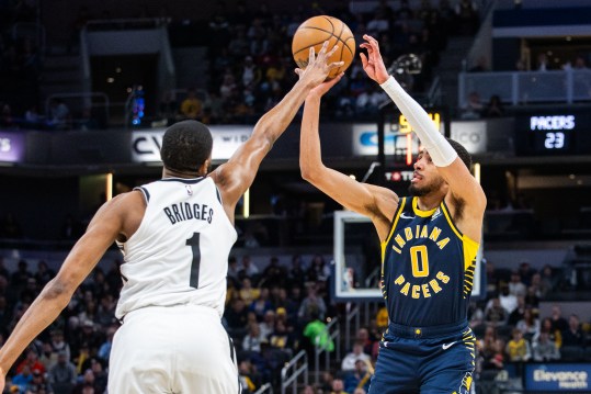 Apr 1, 2024; Indianapolis, Indiana, USA; Indiana Pacers guard Tyrese Haliburton (0) shoots the ball while Brooklyn Nets forward Mikal Bridges (1) (New York Knicks) defends in the first half at Gainbridge Fieldhouse. Mandatory Credit: Trevor Ruszkowski-USA TODAY Sports