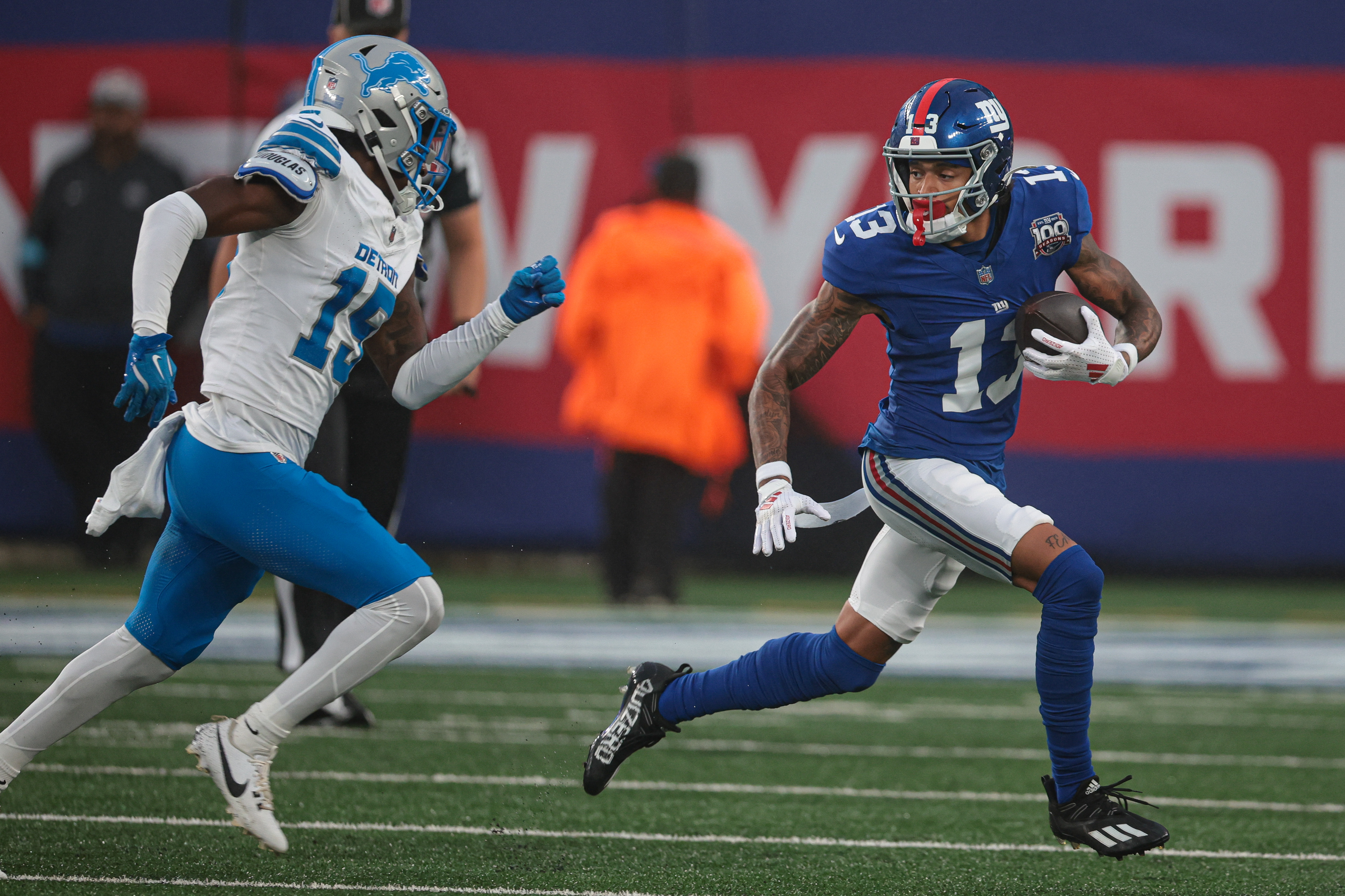 Aug 8, 2024; East Rutherford, New Jersey, USA; New York Giants wide receiver Jalin Hyatt (13) gains yards after catch as Detroit Lions cornerback Ennis Rakestraw Jr. (15) pursues at MetLife Stadium. Mandatory Credit: Vincent Carchietta-USA TODAY Sports