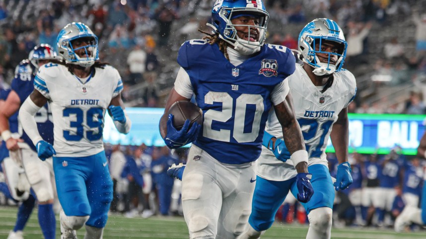 Aug 8, 2024; East Rutherford, New Jersey, USA; New York Giants running back Eric Gray (20) scores a rushing touchdown in front of Detroit Lions cornerback Amik Robertson (21) and cornerback Morice Norris (39) during the first half at MetLife Stadium. Mandatory Credit: Vincent Carchietta-USA TODAY Sports