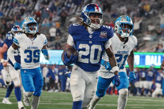 Aug 8, 2024; East Rutherford, New Jersey, USA; New York Giants running back Eric Gray (20) scores a rushing touchdown in front of Detroit Lions cornerback Amik Robertson (21) and cornerback Morice Norris (39) during the first half at MetLife Stadium. Mandatory Credit: Vincent Carchietta-USA TODAY Sports