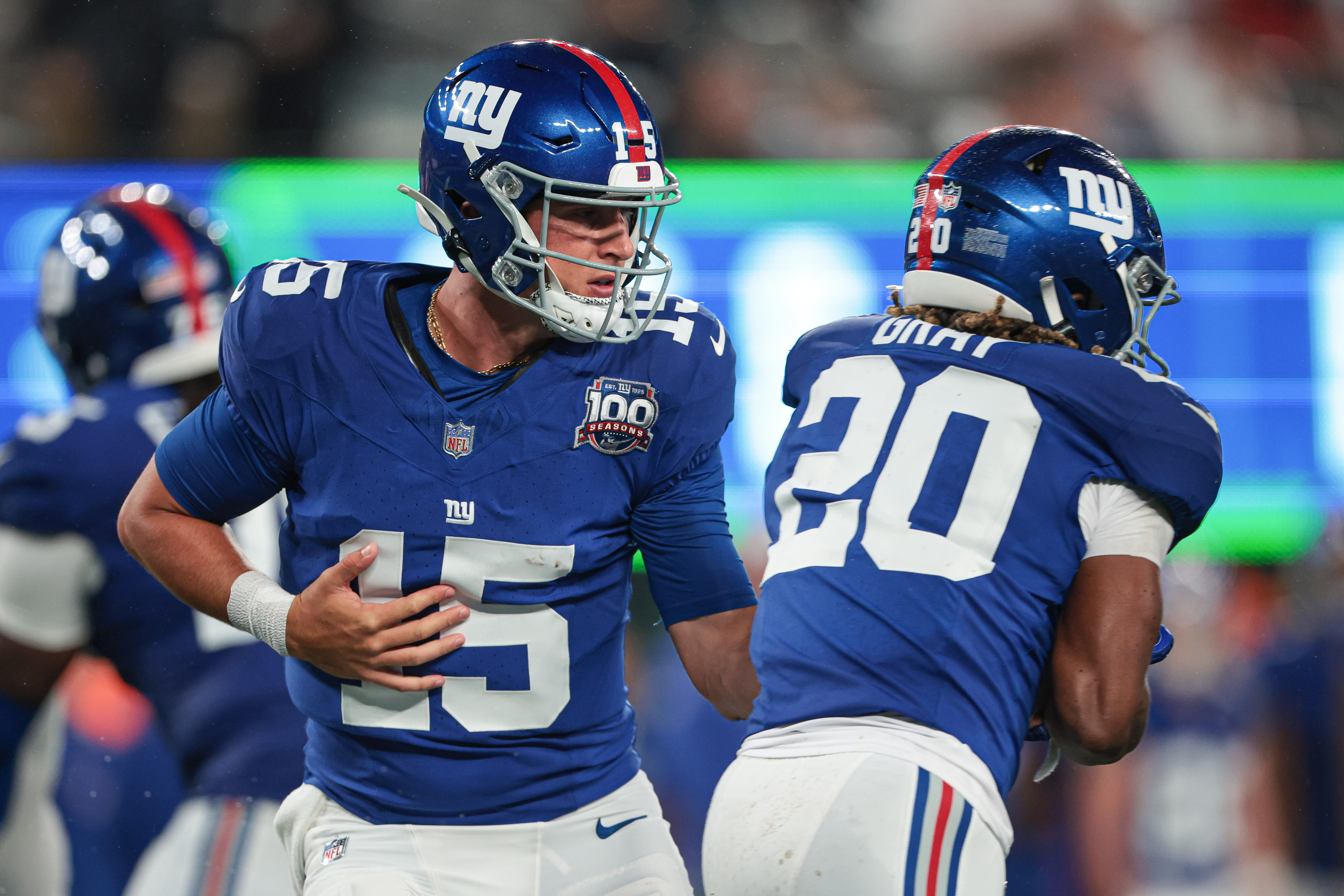 Aug 8, 2024; East Rutherford, New Jersey, USA; New York Giants quarterback Tommy DeVito (15) hands off to running back Eric Gray (20) during the first half at MetLife Stadium. Mandatory Credit: Vincent Carchietta-USA TODAY Sports