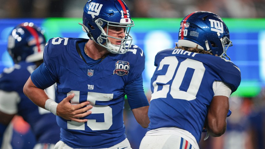 Aug 8, 2024; East Rutherford, New Jersey, USA; New York Giants quarterback Tommy DeVito (15) hands off to running back Eric Gray (20) during the first half at MetLife Stadium. Mandatory Credit: Vincent Carchietta-USA TODAY Sports