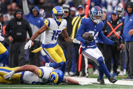 Dec 31, 2023; East Rutherford, New Jersey, USA; New York Giants safety Dane Belton (24) returns an interception as Los Angeles Rams tight end Tyler Higbee (89) and wide receiver Demarcus Robinson (15) pursue during the second half at MetLife Stadium. Mandatory Credit: Vincent Carchietta-USA TODAY Sports