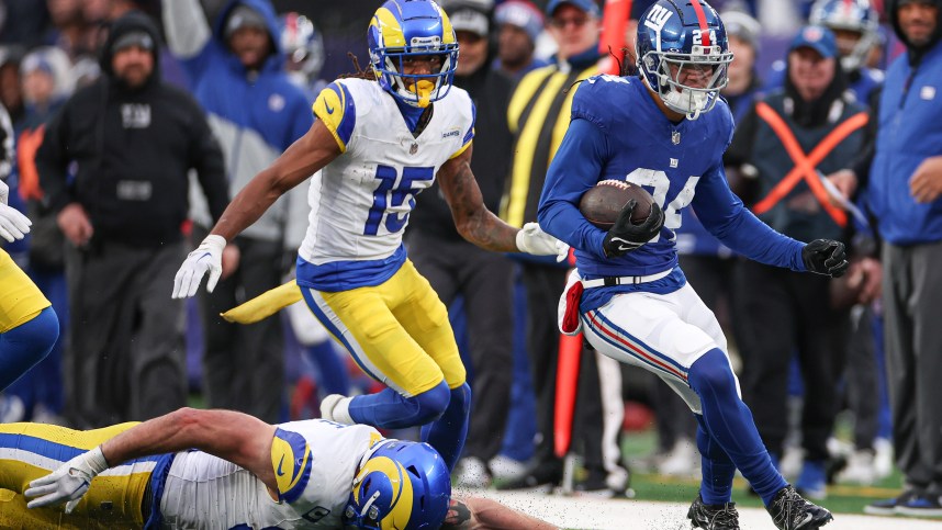 Dec 31, 2023; East Rutherford, New Jersey, USA; New York Giants safety Dane Belton (24) returns an interception as Los Angeles Rams tight end Tyler Higbee (89) and wide receiver Demarcus Robinson (15) pursue during the second half at MetLife Stadium. Mandatory Credit: Vincent Carchietta-USA TODAY Sports